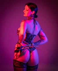 a woman in a corset posing on a purple background